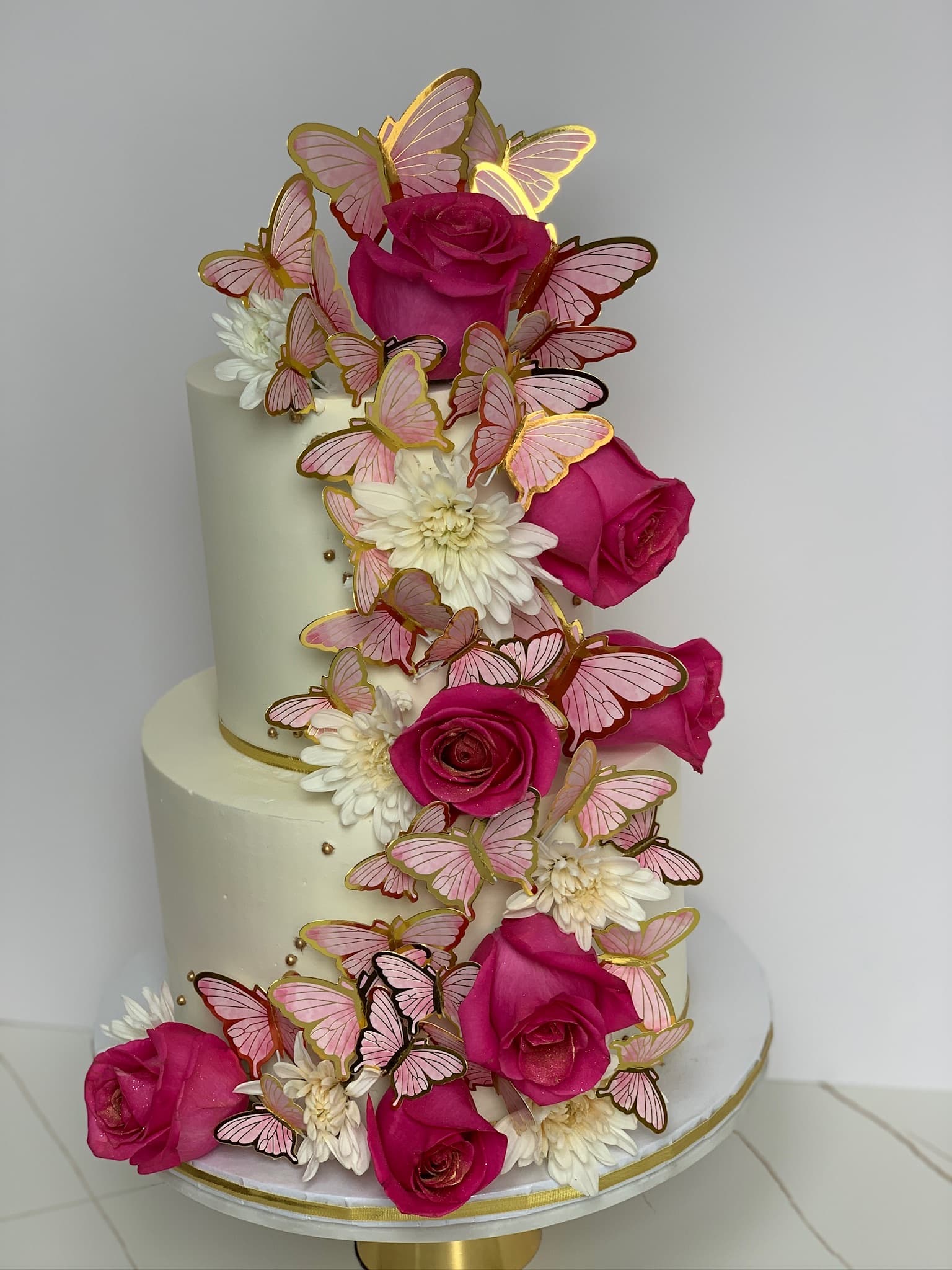 Butterfly and rose two-tier cake