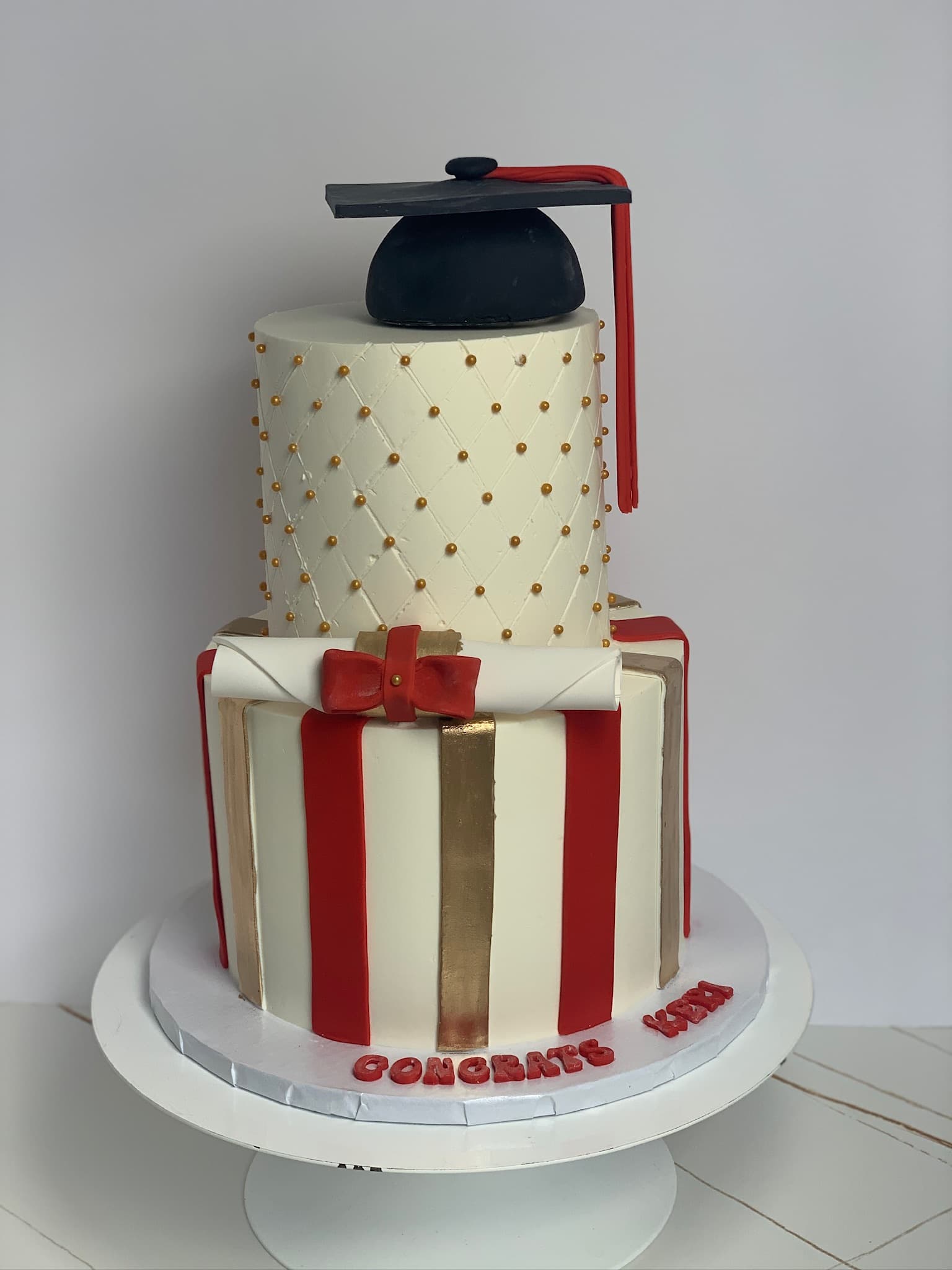 Red and gold quilted graduation two-tier cake