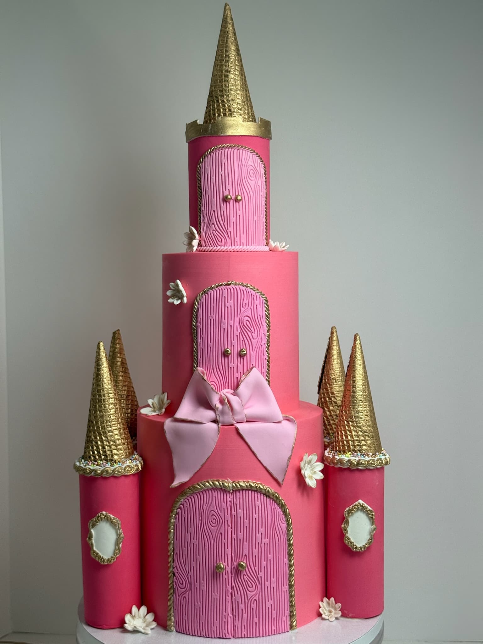 Pink princess castle multi-tier cake