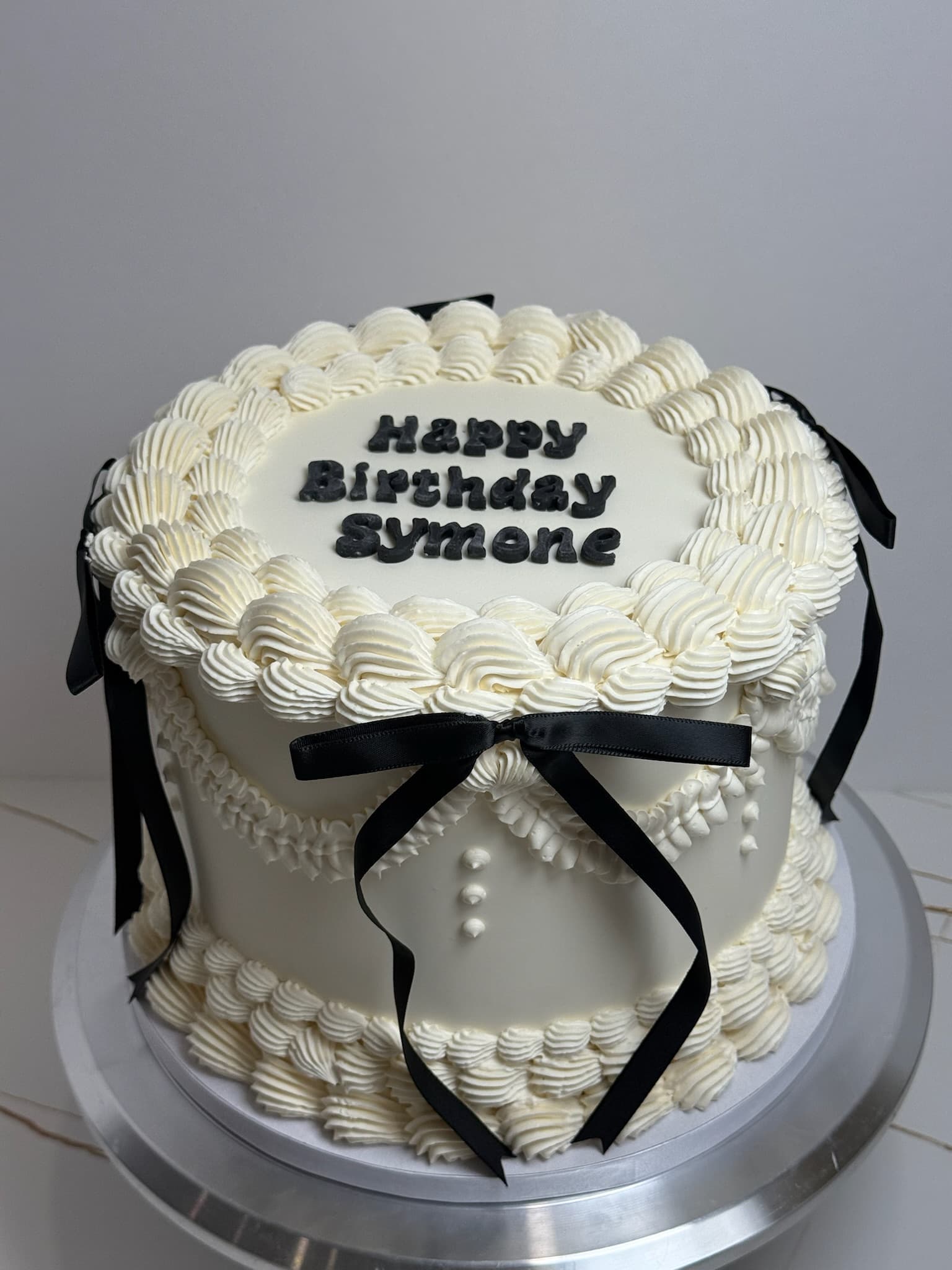 Vintage birthday cake with black bow