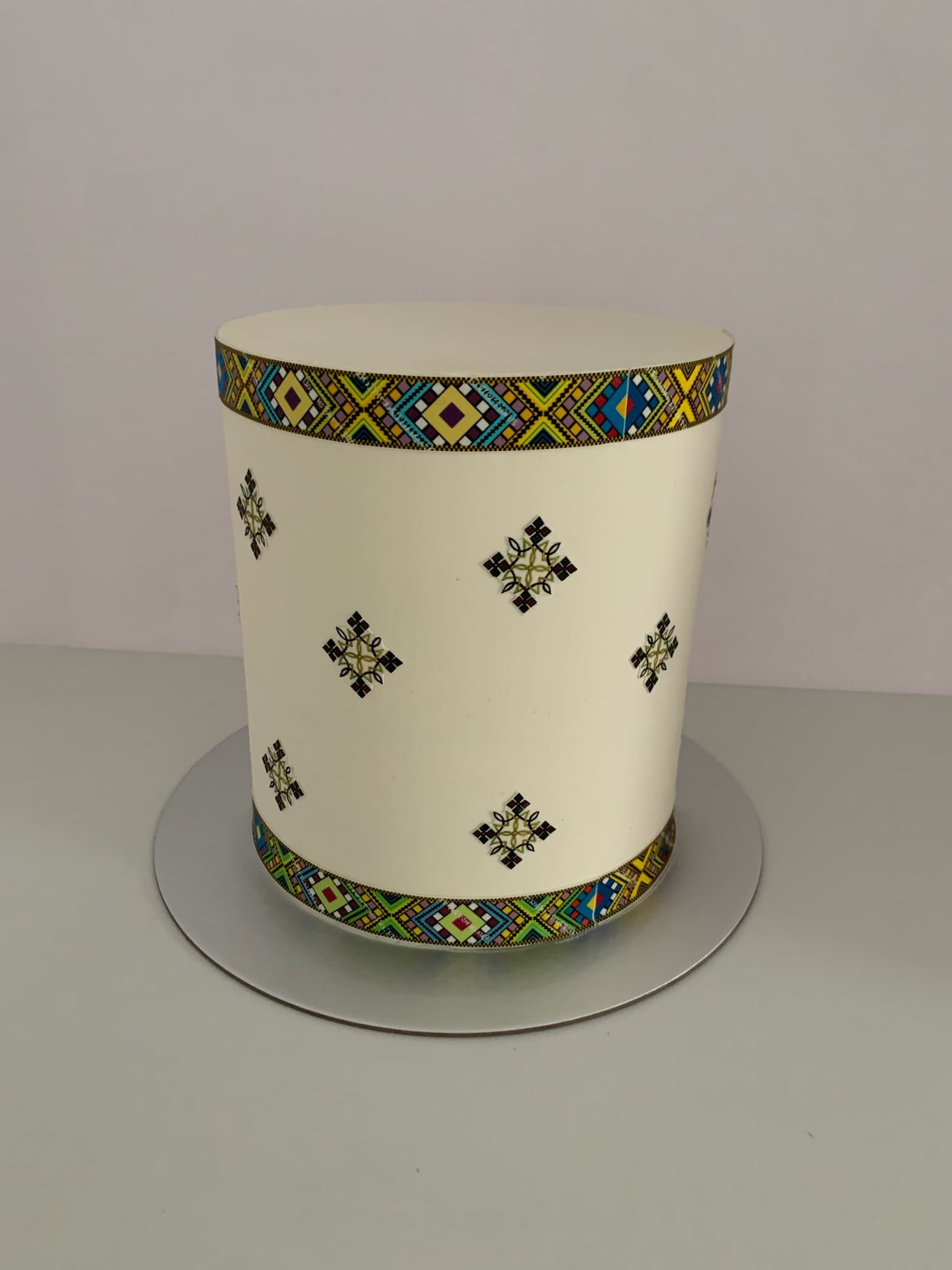 Colorful cross-stitch pattern single tier cake