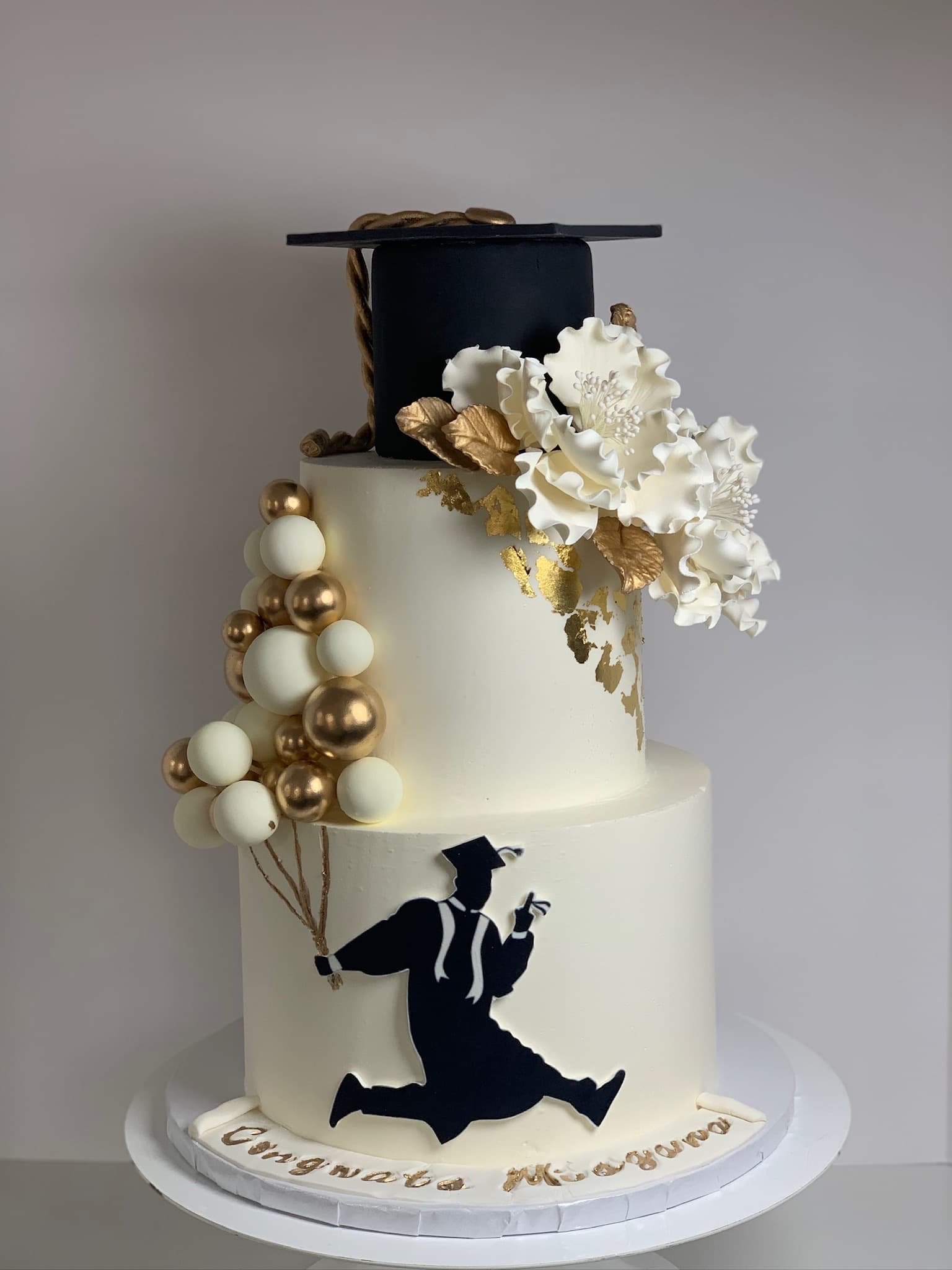 Black and gold graduation silhouette two-tier cake